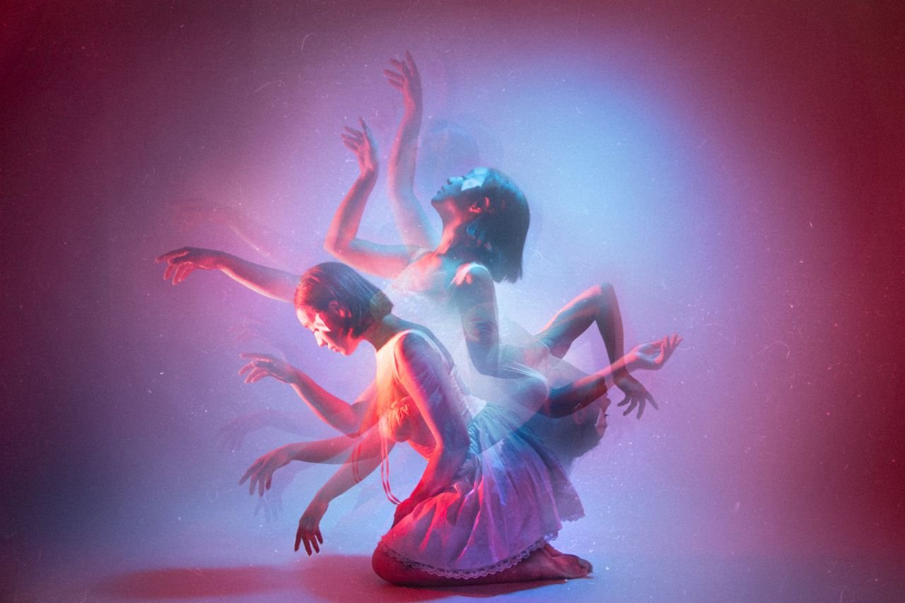 Artistic dance photo in studio with kinetic light effects and blurred motion.